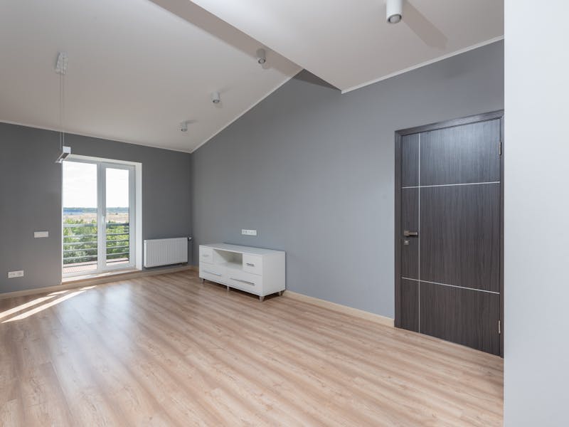 Empty room with clean hardwood floors ready for new tenant